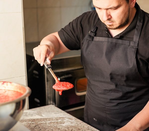 Latin Pizzeria chef cook pizza in professional uniform. restaurant italian cuisine entrepreneur